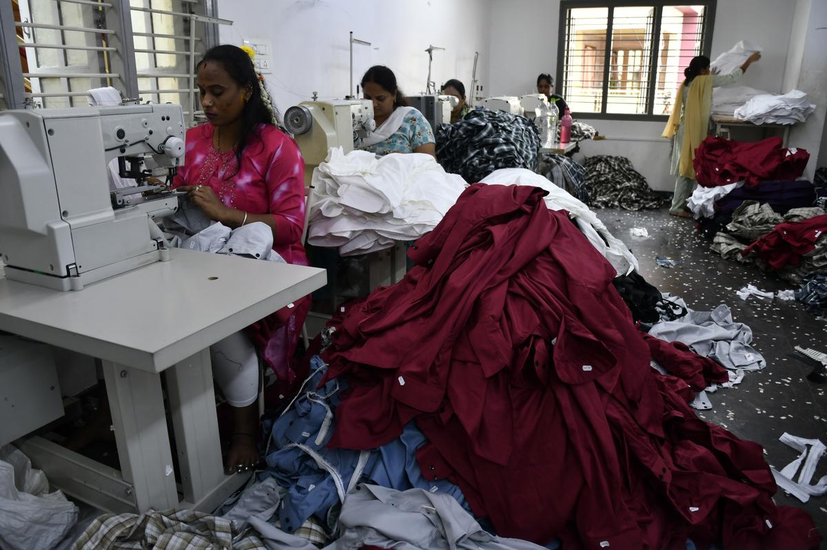 Garment worker tailors clothes on sewing machines at an apparel manufacturing unit in Bengaluru.
