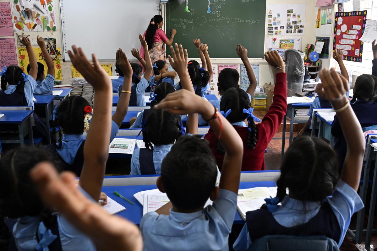 A teacher busy with her job at Sri Atal Bihari Vajpayee Govt. Model Primary School at Kamalanagar in Bengaluru on Wednesday. 