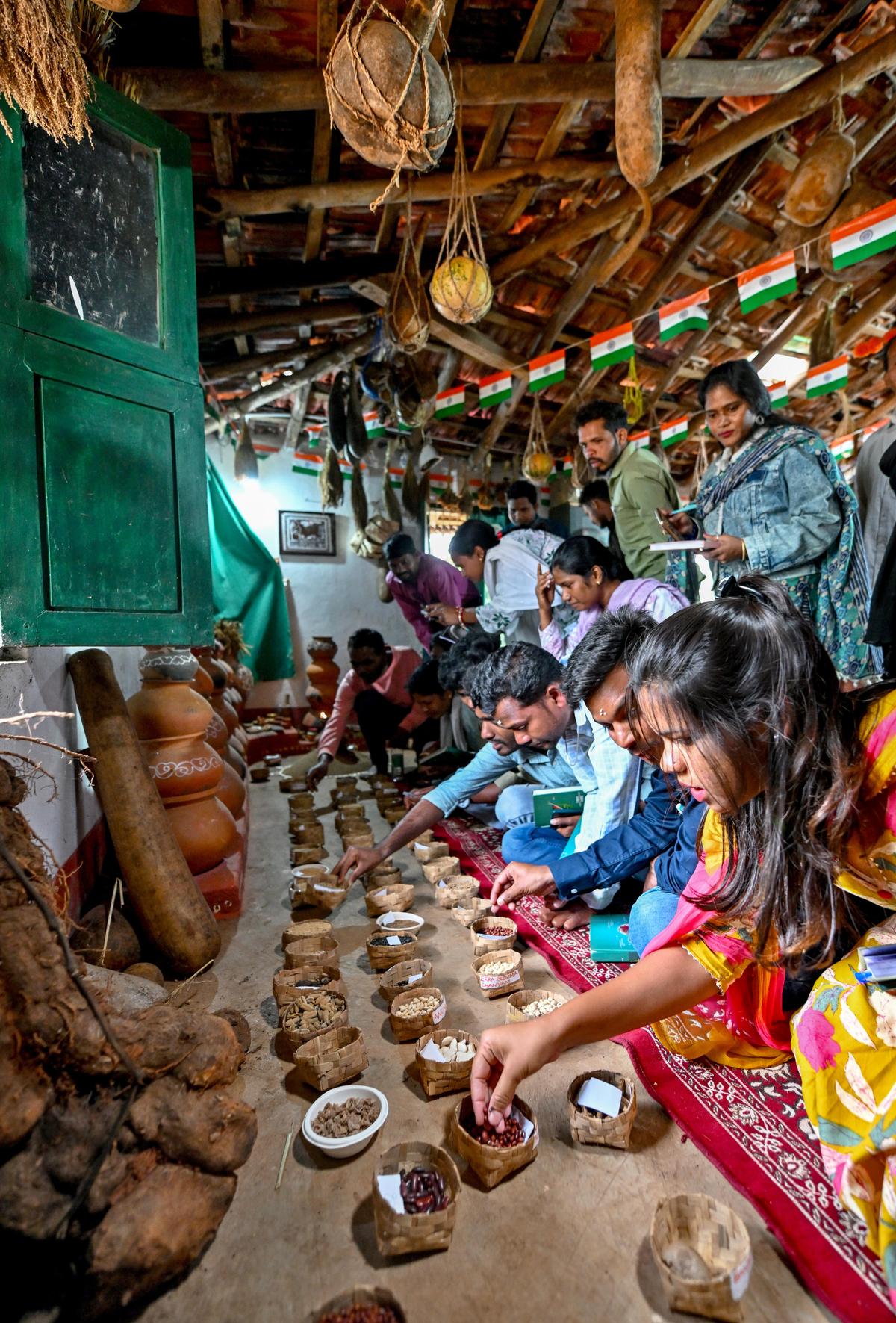 Visitors from Odisha examining the native seed collection at the Soil and Seed Information Centre of Sanjeevini Rural Development Society at Kiloguda in the Eastern Ghats of Andhra Pradesh, about 130 kilometres from Visakhapatnam.